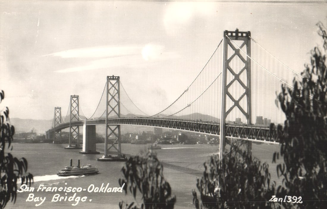 RPPC Real Photo Postcard view of the San Francisco-Oakland Bay Bridge with a ferry boat, California. (1 of 2)