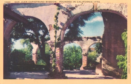 Postcard of the beautiful arched corridors and gardens at San Juan Capistrano Mission in California.