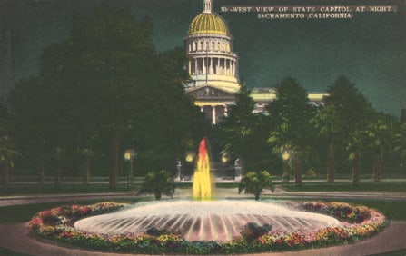 Nighttime postcard view of the illuminated fountain at the State Capitol in Sacramento, California.