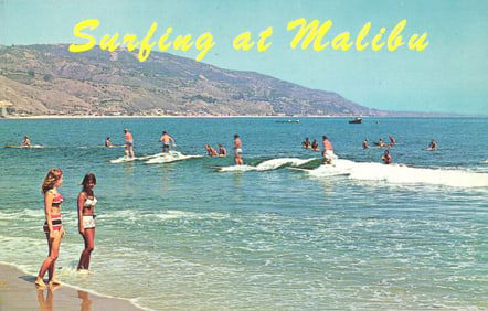 Chrome postcard of surfers riding waves on a sunny day at the famous Malibu Beach, California