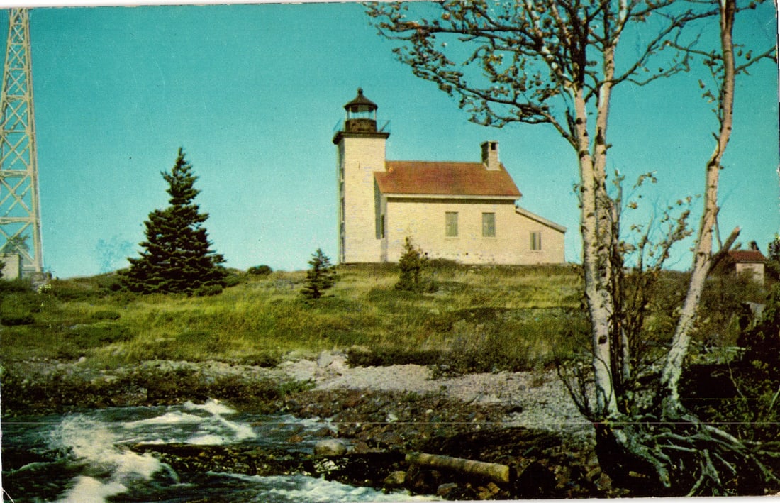 Postcard of The Copper Harbor Light lighthouse on a grassy hill, Copper Harbor, Michigan c. 1954 (1 of 2)