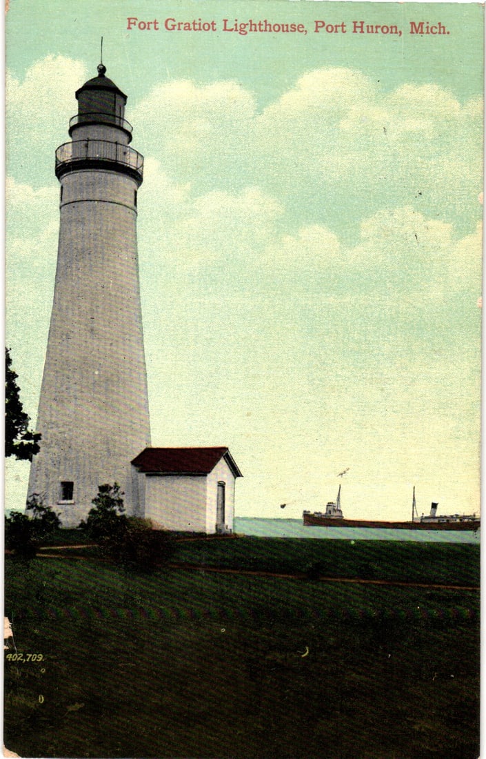 Postcard of the Fort Gratiot Lighthouse in Port Huron, Michigan with a large freighter, c. 1914: Please view photos for further description and condition considerations. Please know the scans may be darker or lighter than the actual item's true appearance. ACME Auctions offers FREE DOMESTIC SHIPP