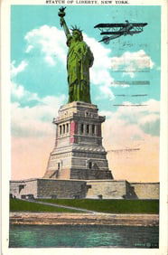 Color postcard showing the Statue of Liberty and a biplane flying over New York Harbor, circa 1930s.