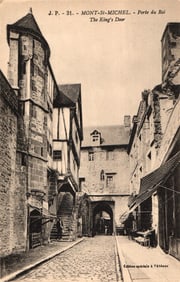 Postcard view of the medieval Porte du Roi, The King's Door, on a street in Mont-Saint-Michel,