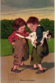 Postcard showing two boys making 'Music at both ends' by playing a cat's tail like a fiddle.