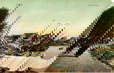 Postcard of Volendam, Netherlands showing the harbor with fishing boats and laundry drying, c. 1908.