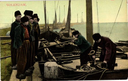 Postcard showing fishermen in traditional Dutch clothing on the docks of Volendam, Netherlands c.