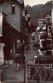 Postcard view of the steep cobblestone street with donkeys in Clovelly, Devon, England c. 1920s
