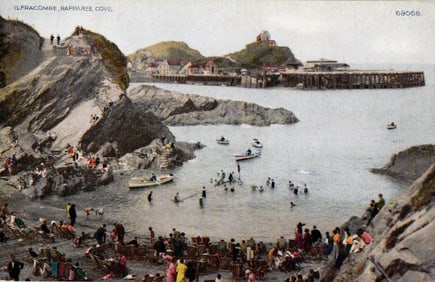 Postcard showing Rapparee Cove in Ilfracombe, Devon with swimmers and boats near the beach, c. 1910s