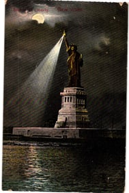 Postcard showing the Statue of Liberty at night with a full moon and a bright spotlight from its
