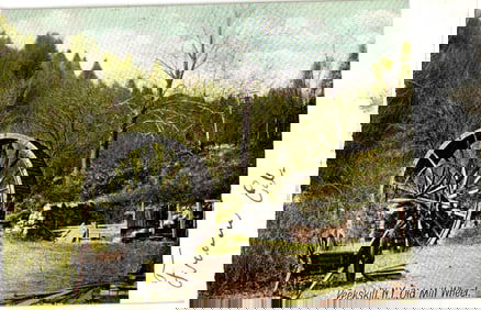 Postcard showing the Old Mill Wheel with a man nearby in a rustic Peekskill, New York scene c. 1907.