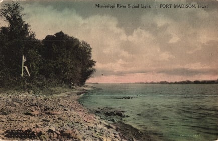 Postcard view of the Mississippi River Signal Light on the rocky shoreline in Fort Madison, Iowa