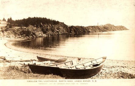 RPPC view of boats on shore with Swallow Tail Lighthouse, North Head, Grand Manan, New Brunswick