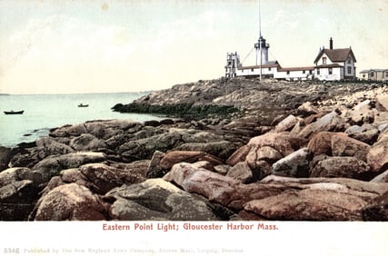 Postcard view of the Eastern Point Light on the rocky shoreline of Gloucester Harbor, Massachusetts.