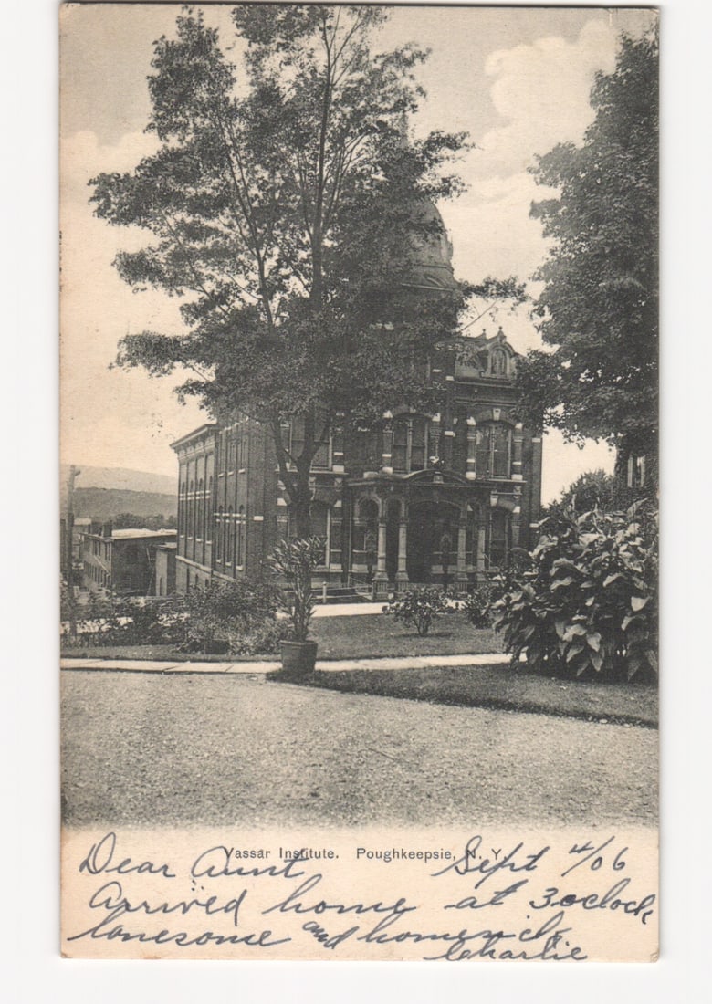Historic Vassar Institute Building, Poughkeepsie, New York, circa 1906 photographic postcard.: A large, multi-story brick building with a distinctive domed roof and elaborate architectural details, including columns and balconies. A substantial mature tree stands prominently in the foreground, 