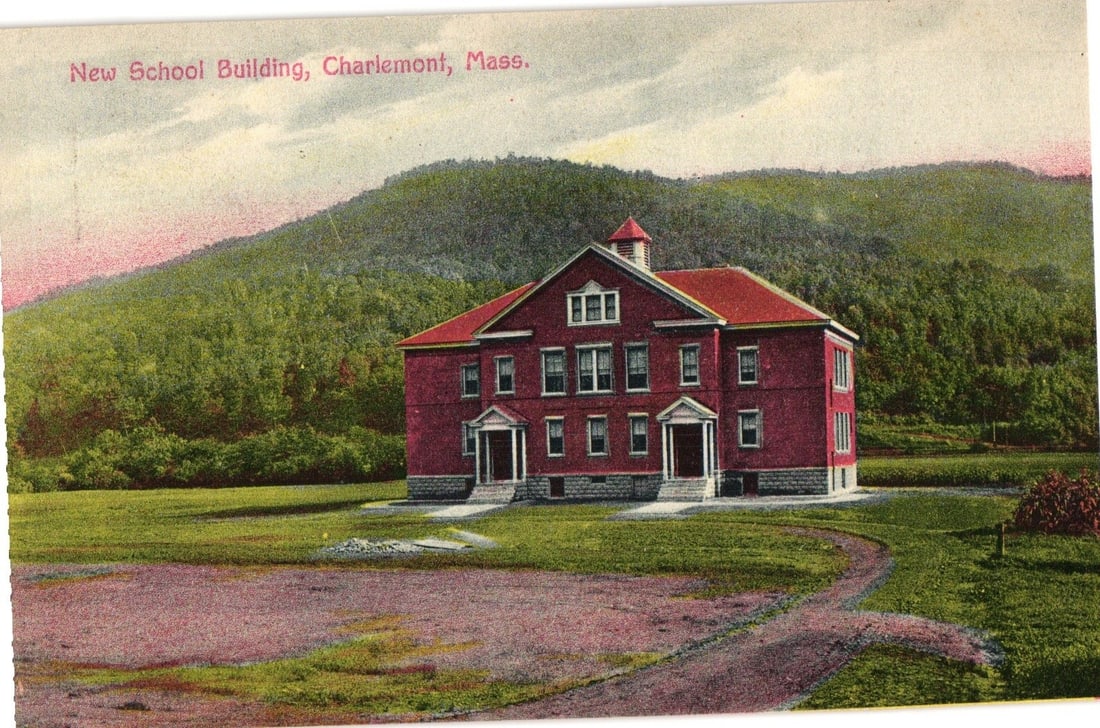 Early 20th Century Lithograph Postcard of New School Building in Charlemont, Massachusetts.: A large, red brick school building with a distinctive red-tiled hip roof and a small cupola at its peak is centrally depicted. The building features two prominent front entrances, each with white colu