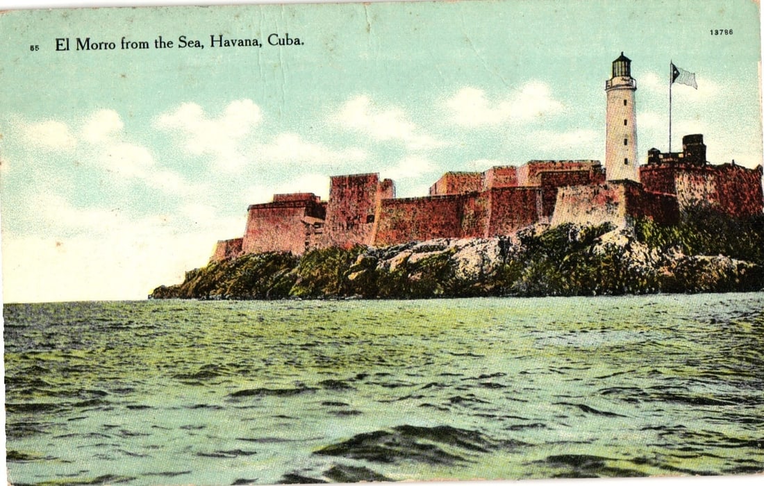 Early 20th Century Havana, Cuba: El Morro Fortress and Lighthouse Seascape Postcard: A colorized postcard depicting El Morro fortress and lighthouse in Havana, Cuba, as seen from the sea. The massive stone fortress walls rise from a rocky promontory, with a tall lighthouse featuring a