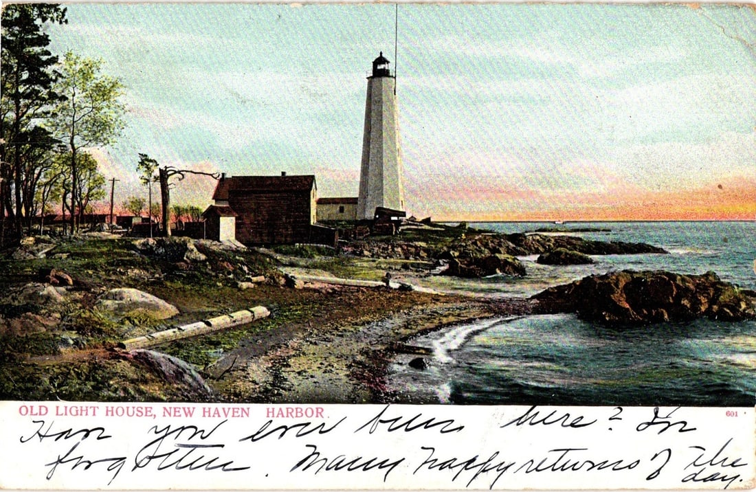 Old Lighthouse, New Haven, Connecticut Harbor, Early 20th Century Lithograph Postcard: A chromolithograph postcard depicts a tall white lighthouse standing on a rocky point overlooking a body of water. To the left, a small dark building is situated near a wooded area with mature trees. 