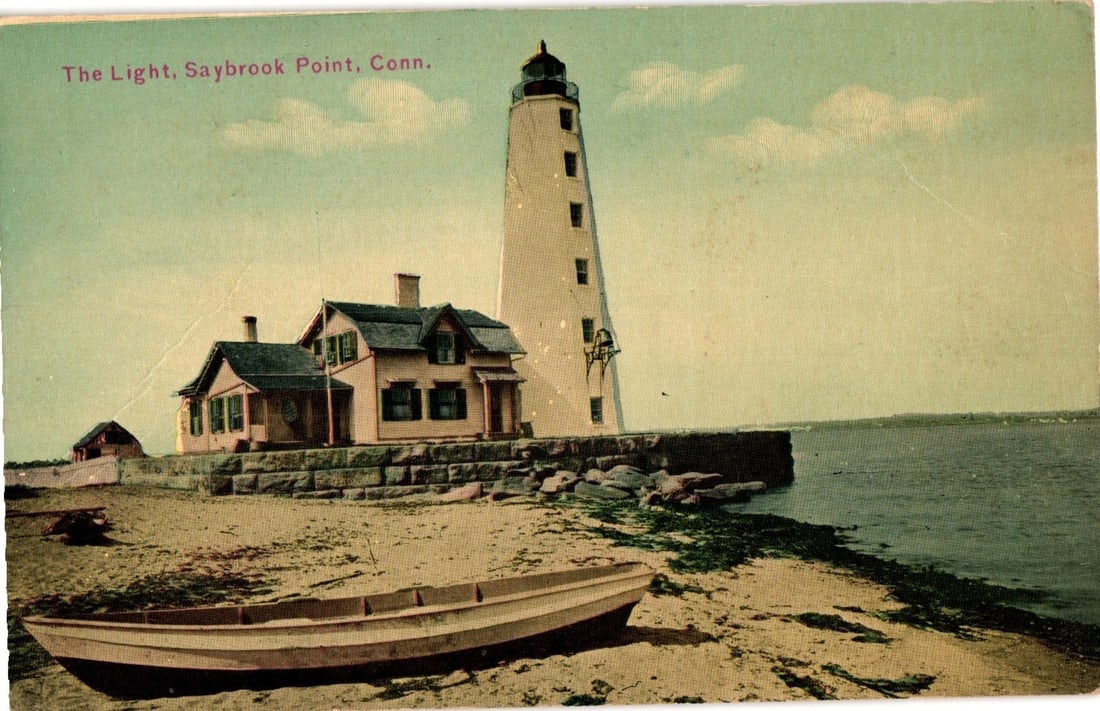 Scenic Early 1900s Color Lithograph Postcard Featuring Saybrook Point Lighthouse, Connecticut: A lighthouse with a black lantern room stands tall on a stone foundation, accompanied by a complex of two gabled residential buildings with dark roofs and chimneys. The structures are situated on a lo