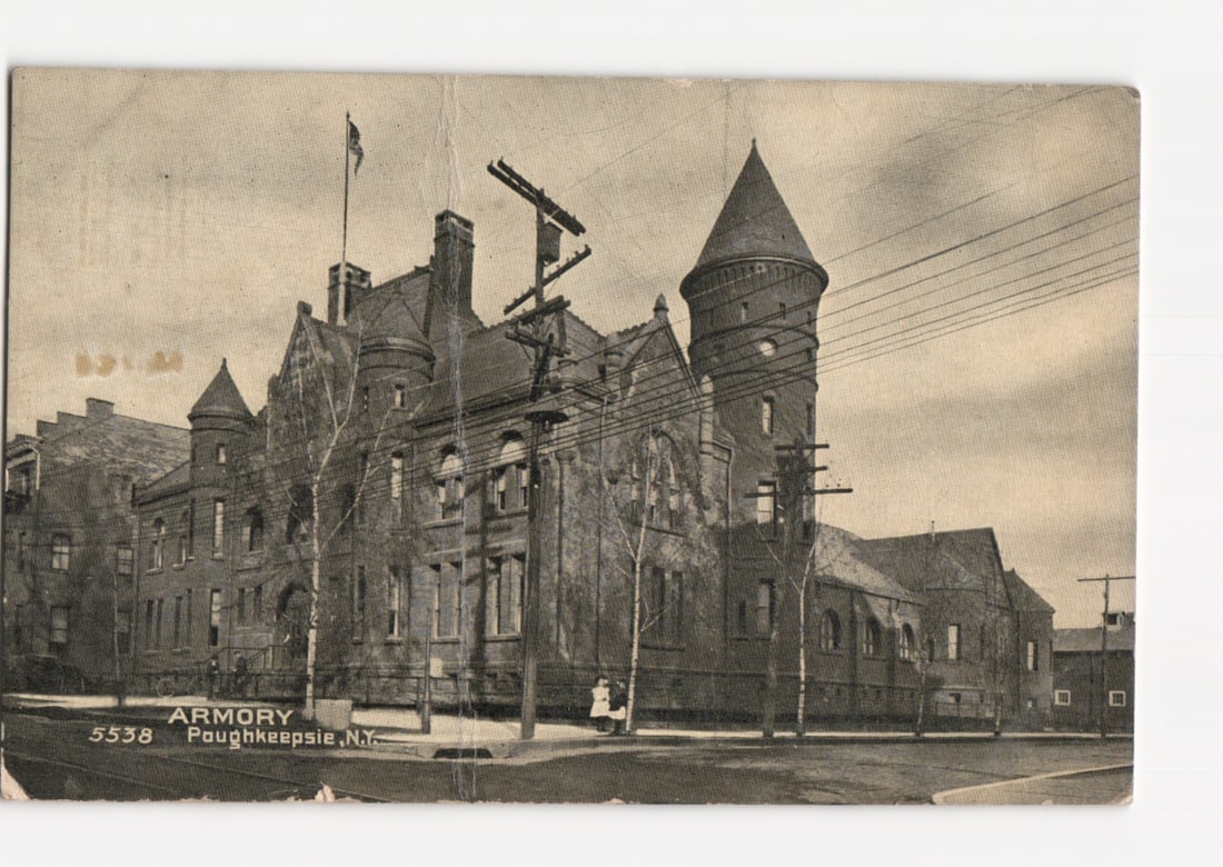 Armory building, Poughkeepsie, New York, early 1900s street view architectural postcard.: A monochrome photographic illustration depicts a large, multi-story stone armory building. Architectural details include a prominent conical turret, smaller turrets, and arched windows. A flag is visi