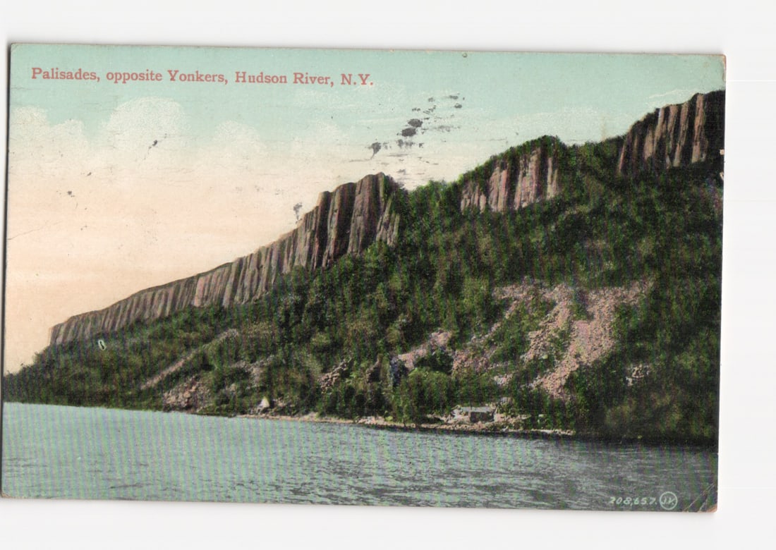 Palisades Cliffs on Hudson River, opposite Yonkers, New York, early 20th Century postcard: Panoramic view of the Palisades cliffs rising from the Hudson River. Steep, verdant slopes covered in trees and vegetation lead up to rugged rock formations. A small structure is visible at the base o