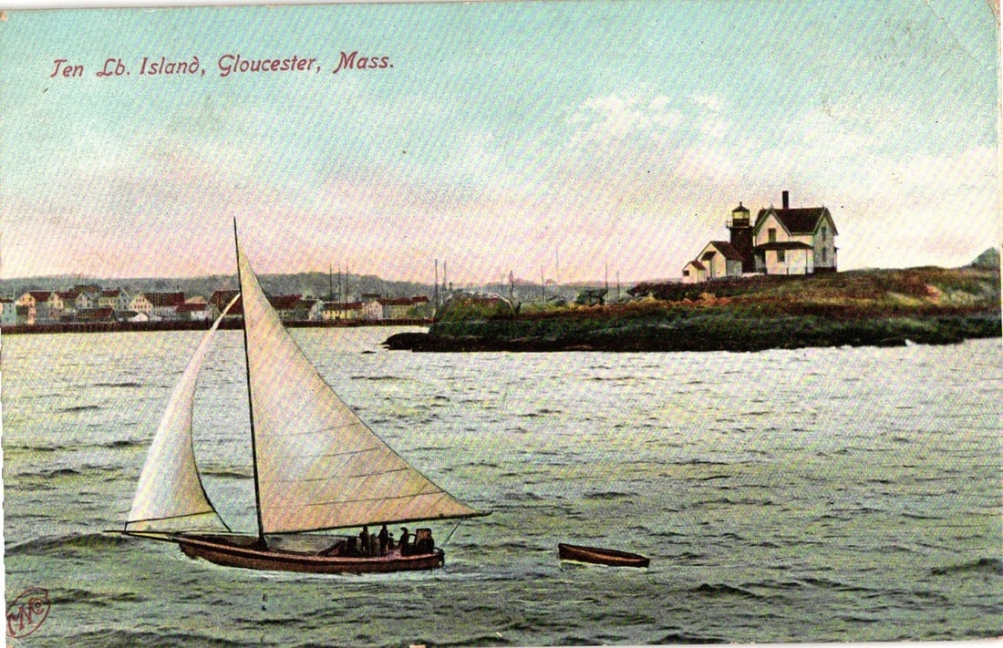 Colorized postcard of a sailboat near Ten Pound Island Lighthouse, Gloucester, Mass.: A sailboat with two sails and three visible figures navigates calm waters, occupying the mid-left foreground. In the middle ground, a prominent lighthouse with a dark top stands on Ten Pound Island, f
