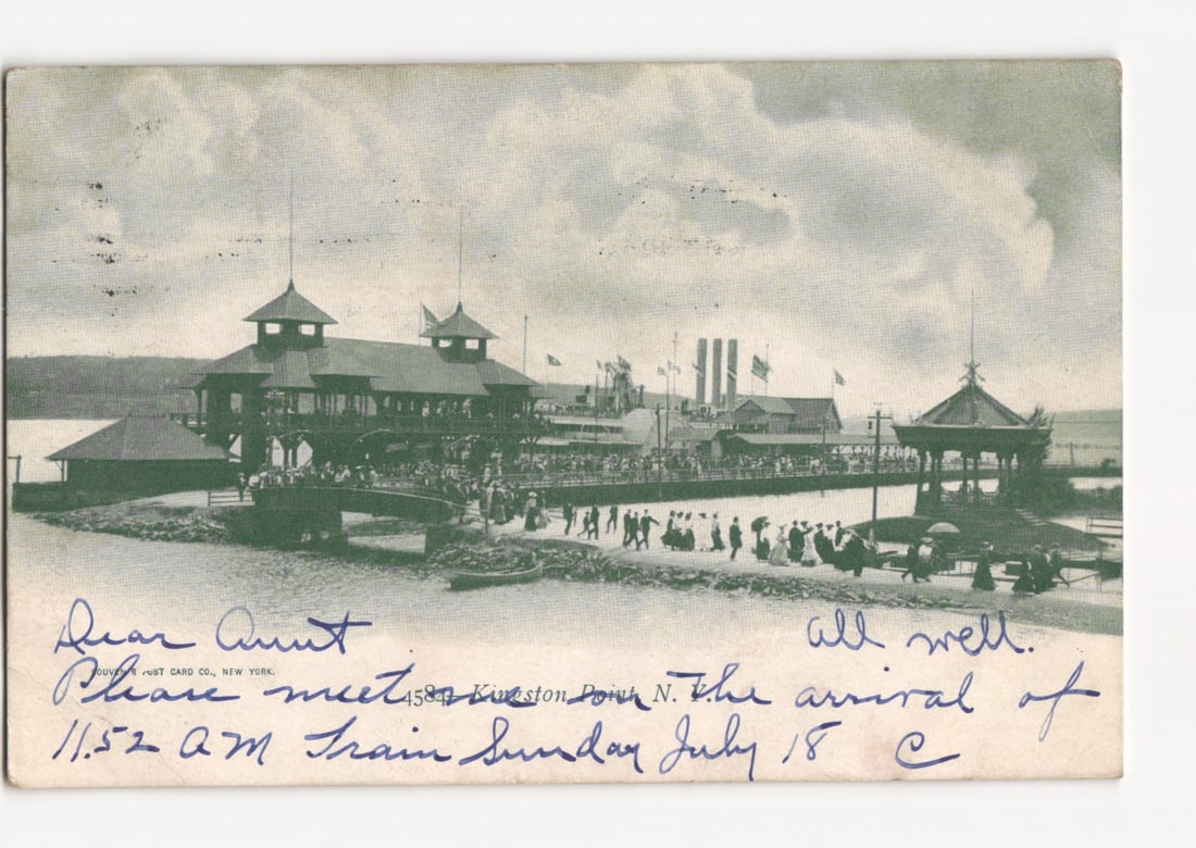 View of Kingston Point, New York, with Steamboat Landing and Pavilion, circa 1909 postcard: A printed photographic postcard depicting the steamboat landing and pavilion at Kingston Point, New York. A large two-story wooden pavilion with multiple gabled roofs extends into the water, crowded w
