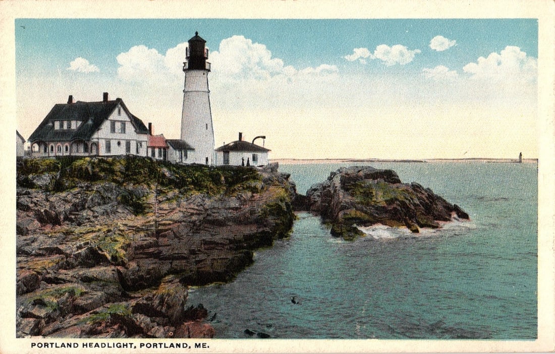 Scenic chromolithograph postcard of Portland Headlight Lighthouse, keeper's house, Portland, Maine.: A scenic view of the Portland Headlight lighthouse, situated on a rocky promontory overlooking the ocean. The white lighthouse tower with a black lantern room stands prominently to the right of a larg