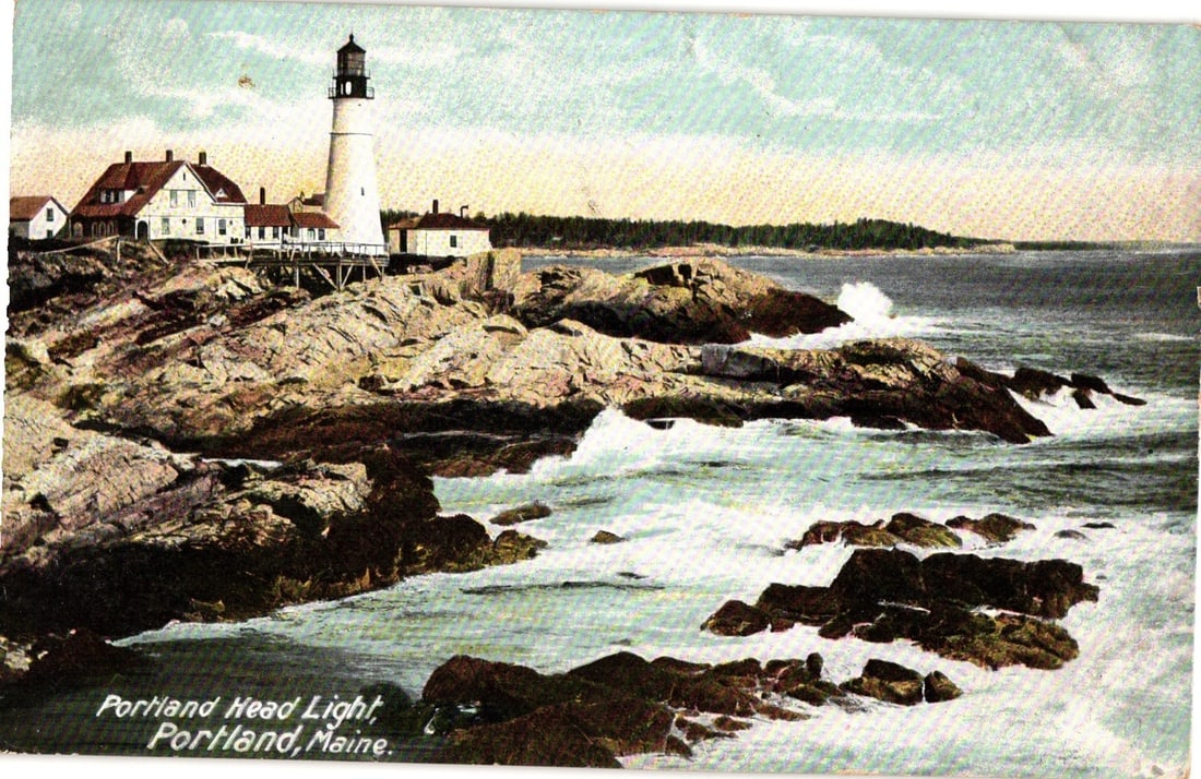 Portland Head Light and Rocky Coastline, Portland, Maine, Early 20th Century Lithograph Postcard: A scenic view depicts the Portland Head Light lighthouse and its associated white buildings situated on a rocky promontory overlooking the ocean. The light tower is tall and white with a dark lantern 