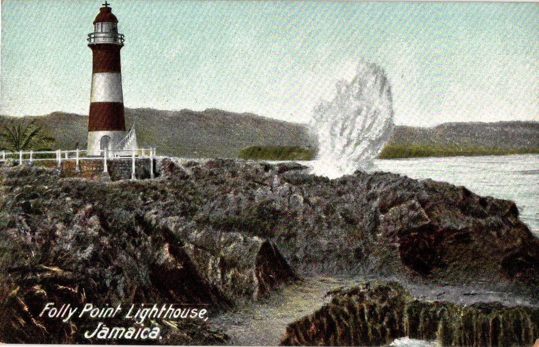 Folly Point Lighthouse, Jamaica, with Crashing Waves, a Pre-1907 Era Lithograph Postcard.: A color lithograph postcard depicts the Folly Point Lighthouse in Jamaica. The lighthouse, a cylindrical tower with red and white horizontal stripes, stands on a rocky promontory on the left side. It 