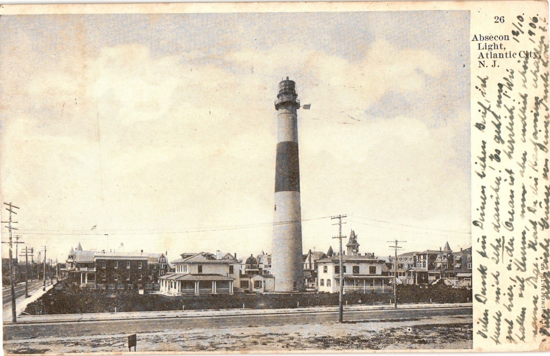 Absecon Light Lighthouse, Atlantic City, New Jersey, circa 1906, Architectural Postcard.: A tall, cylindrical lighthouse, the Absecon Light, stands prominently in the center-right of the image. The lighthouse features distinct horizontal bands of color, appearing dark on the lower section 