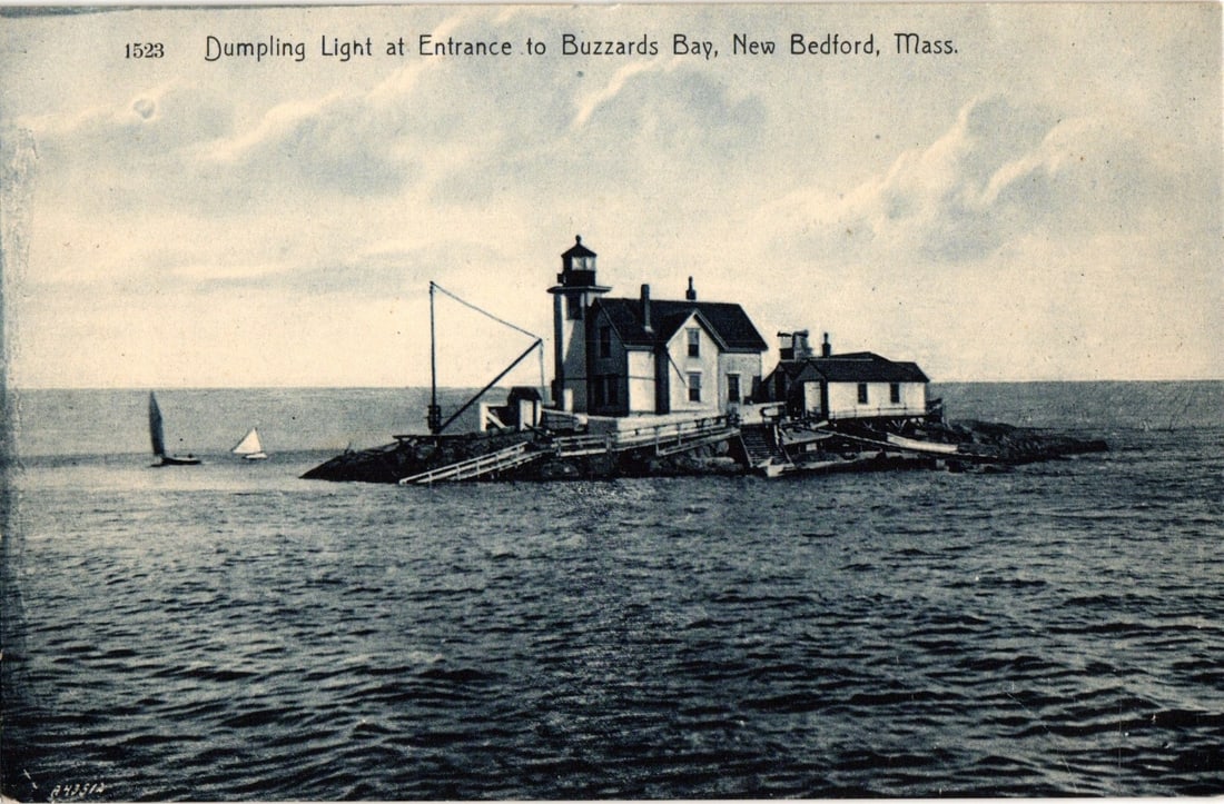 Dumpling Light at Entrance to Buzzards Bay, New Bedford, Mass. Lighthouse View Postcard: A black and white printed photographic view captures Dumpling Light, situated on a rocky islet in the water. The lighthouse structure, featuring a tower and connected residential buildings, occupies t