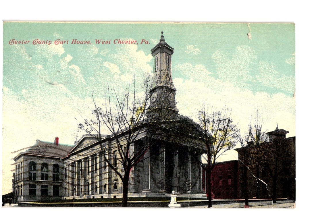 Historic Chester County Court House, West Chester, PA, early 20th-century architectural postcard.: A classical revival style building featuring a grand portico with columns and a multi-tiered clock tower dominating the center. Bare trees are positioned in the foreground and around the structure. Ad
