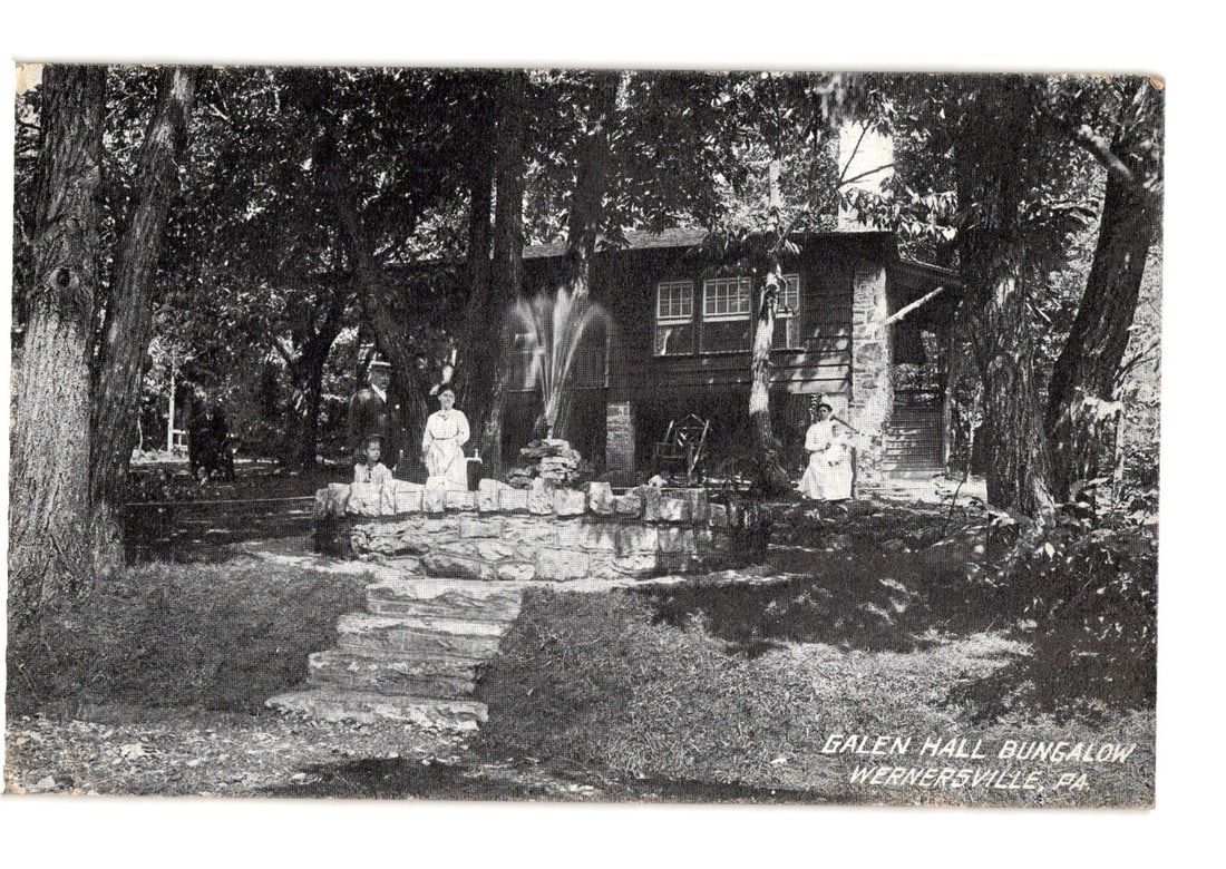 Scenic View of Galen Hall Bungalow in Wernersville, PA, a 1912 photographic postcard: A black and white photographic postcard depicts the Galen Hall Bungalow in Wernersville, PA. The bungalow, a multi-story structure with visible windows, is nestled among numerous mature trees, with br