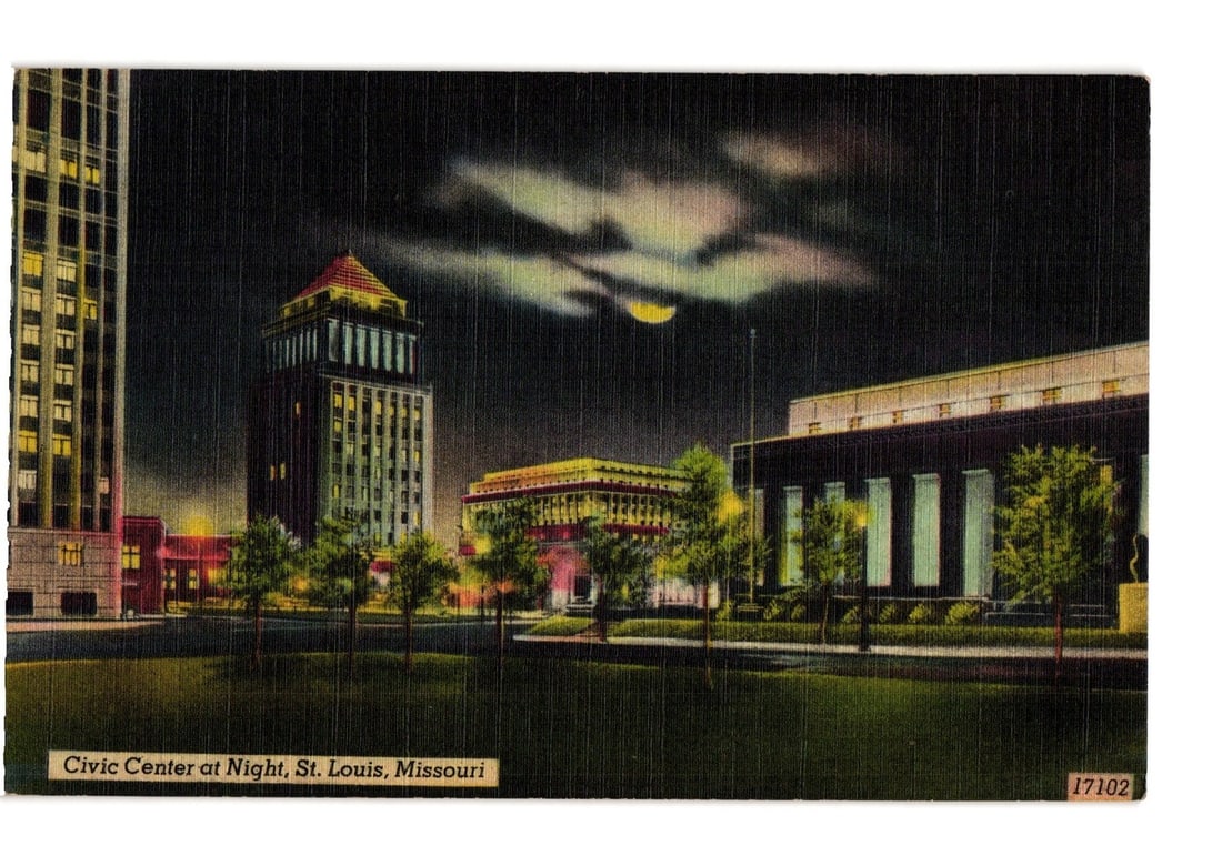 St. Louis, Missouri: Civic Center at Night, Mid-20th Century Photochrome Postcard View: A night view depicts the Civic Center in St. Louis, Missouri. The composition features multiple prominent buildings under a dark sky with a visible moon and clouds. A tall, multi-story building stands