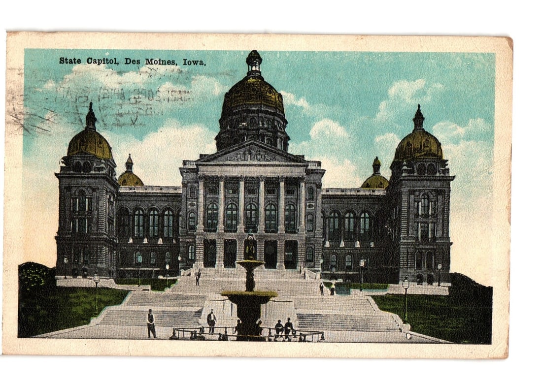 Early 20th Century Chromolithograph Postcard: Iowa State Capitol, Des Moines, Iowa: A grand architectural structure, the Iowa State Capitol Building, stands centrally under a light blue sky with white clouds. The building features a large central golden dome flanked by two smaller go