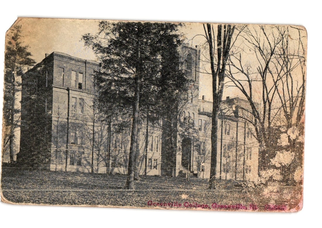 Greenville College Main Building, Greenville, Illinois, Early 20th Century Photographic postcard: A large, multi-story institutional building, identified as Greenville College, stands prominently on a grassy incline. The brick structure features numerous windows, a visible tower section with arche