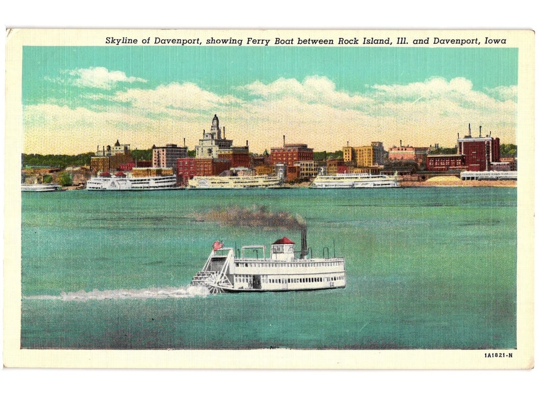 Historic Chromolithograph Postcard: Davenport, Iowa Skyline with Ferry to Rock Island, Illinois: A paddle-wheel ferry boat with a red smokestack and an American flag moves across a body of water, leaving a visible wake. In the background, the skyline of a city features numerous multi-story buildi