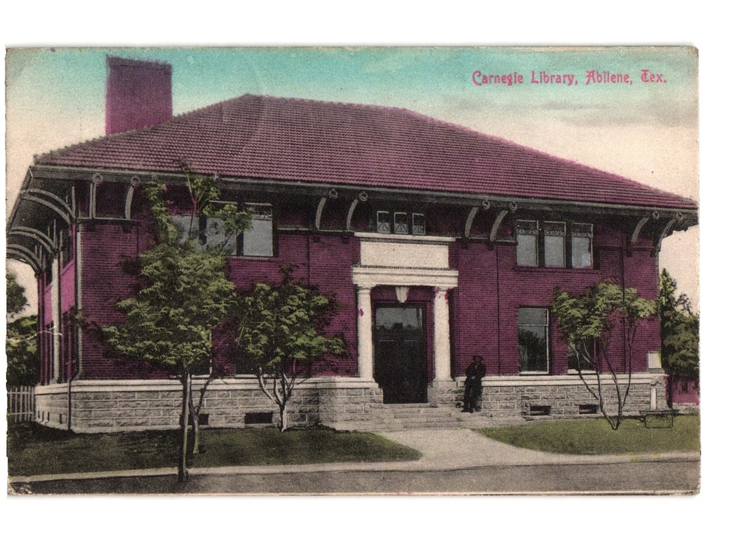 Carnegie Library, Abilene, Texas, early 20th century architectural view postcard.: A chromolithograph postcard depicting the Carnegie Library in Abilene, Texas. The red brick building features a dark tiled hip roof and a prominent entrance with white columns and trim. A stone founda