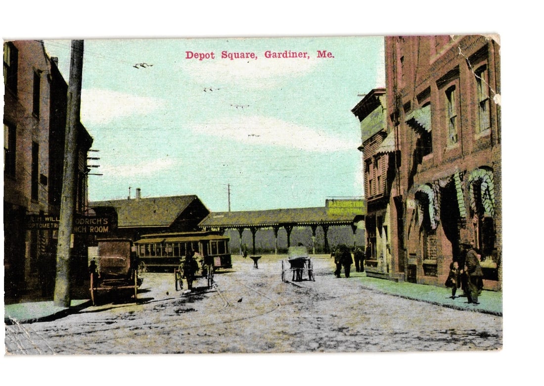 Historic Maine postcard: Depot Square, Gardiner, with streetcar, horse-drawn carts, and buildings.: A street view of Depot Square in Gardiner, Maine. The scene features a streetcar, multiple horse-drawn carts, and pedestrians amidst commercial buildings. The perspective is from street level, looking