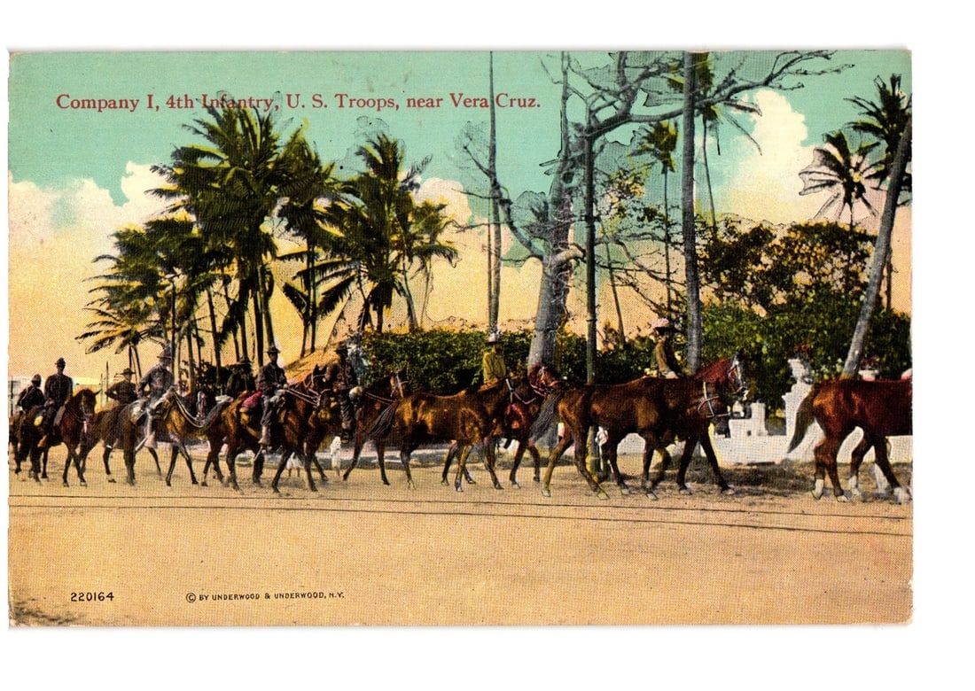 Company I, 4th Infantry U.S. Troops on horseback, Vera Cruz, Mexico, early 20th C. postcard: A column of U.S. Troops from Company I, 4th Infantry, ride on horseback across a light-colored path, moving left to right. They wear uniforms and hats. Tall palm trees dominate the background, with lu