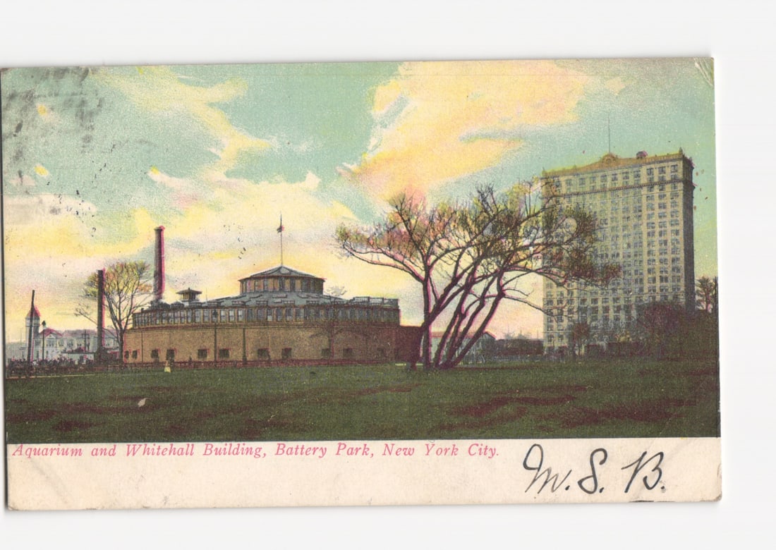 Historic New York City Postcard: Battery Park's Aquarium and Whitehall Building, early 20th century.: A hand-colored lithograph postcard depicting the Aquarium and Whitehall Building in Battery Park, New York City. The scene presents a wide view, with a large grassy expanse in the foreground. The circ
