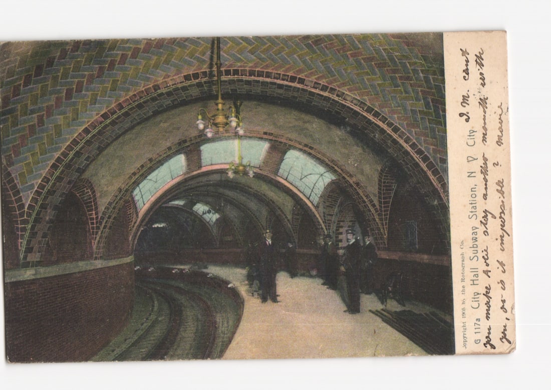 1905 City Hall Subway Station, New York City, featuring elegant architecture and passengers: An interior view of the City Hall Subway Station in New York City depicts multiple arched tunnels constructed with brick and tiled ceilings. Ornate chandeliers illuminate the station, where several me