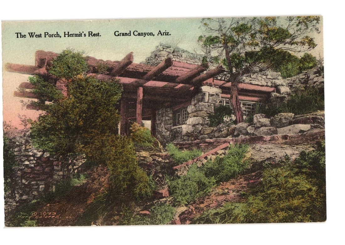 The West Porch, Hermit's Rest, Grand Canyon, Arizona, Hard-Colored Scenic View Postcard: A rustic stone and log structure, identified as The West Porch of Hermit's Rest, is depicted amid a rocky, tree-covered landscape at Grand Canyon, Arizona. The building features thick stone walls and 