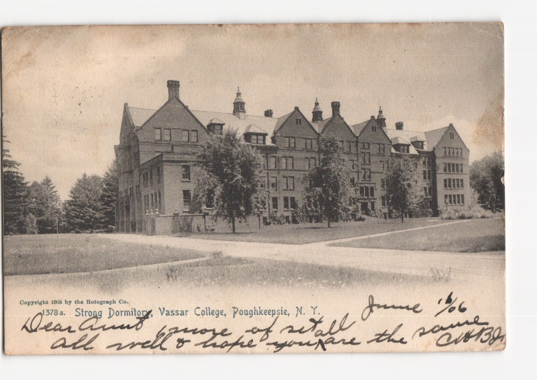 Historic Strong Dormitory, Vassar College, Poughkeepsie, NY, 1905-dated Rotograph postcard.: A large, multi-story brick dormitory building with numerous windows and gabled roofs. It is surrounded by expansive grassy lawns and mature trees. The building is centrally framed, viewed from a sligh