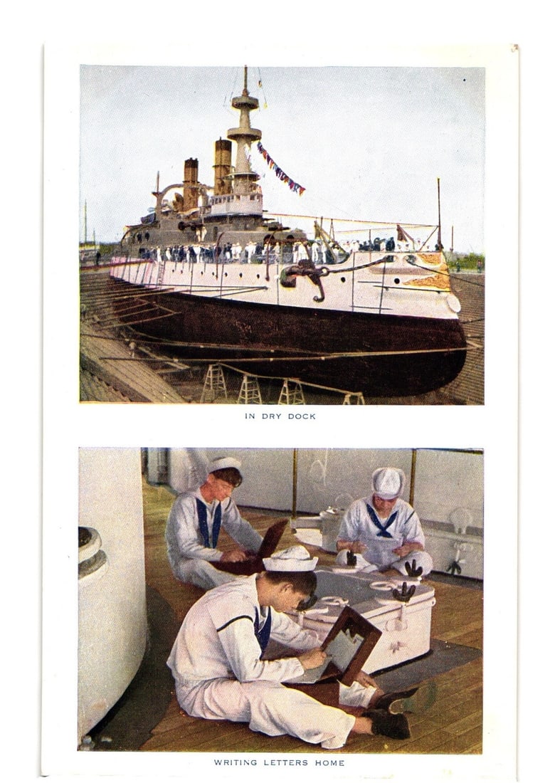 Naval battleship in dry dock and sailors writing letters home, early 20th century postcard: Two distinct colorized photographic scenes are featured on the front. The upper scene depicts a large naval battleship positioned within a dry dock, viewed from the bow with a slight starboard angle. 