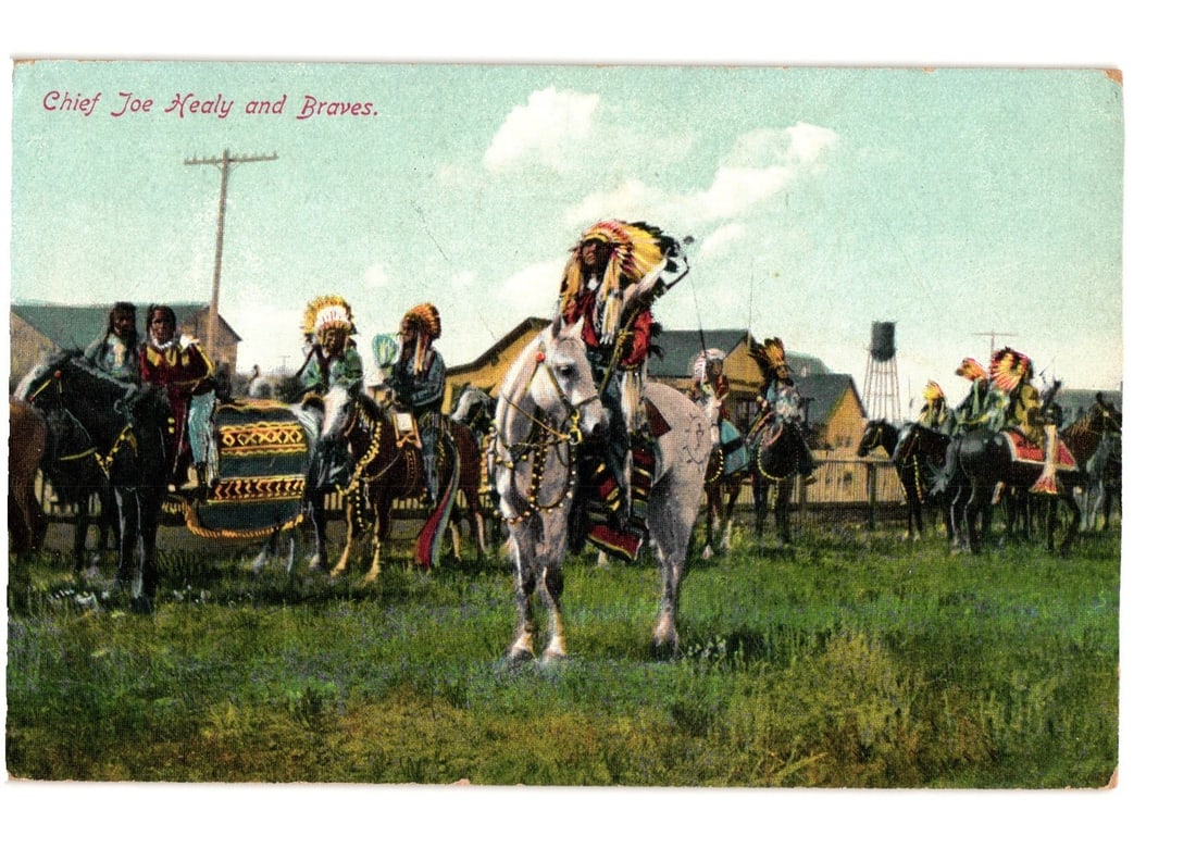 Chief Joe Healy and Braves Native American horsemen postcard, early 20th century chromolithograph.: A group of Native American figures mounted on horses. The central figure, on a white horse and facing forward, wears a large feather headdress and holds a spear or staff. Several other figures in trad
