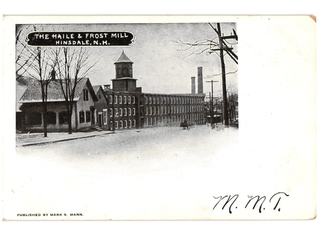 Haile & Frost Mill in Hinsdale, N.H., early 20th century industrial building postcard.: A photographic print depicts the Haile & Frost Mill in Hinsdale, N.H. The main structure is a long, multi-story industrial building with numerous windows, featuring a prominent, four-story tower with 