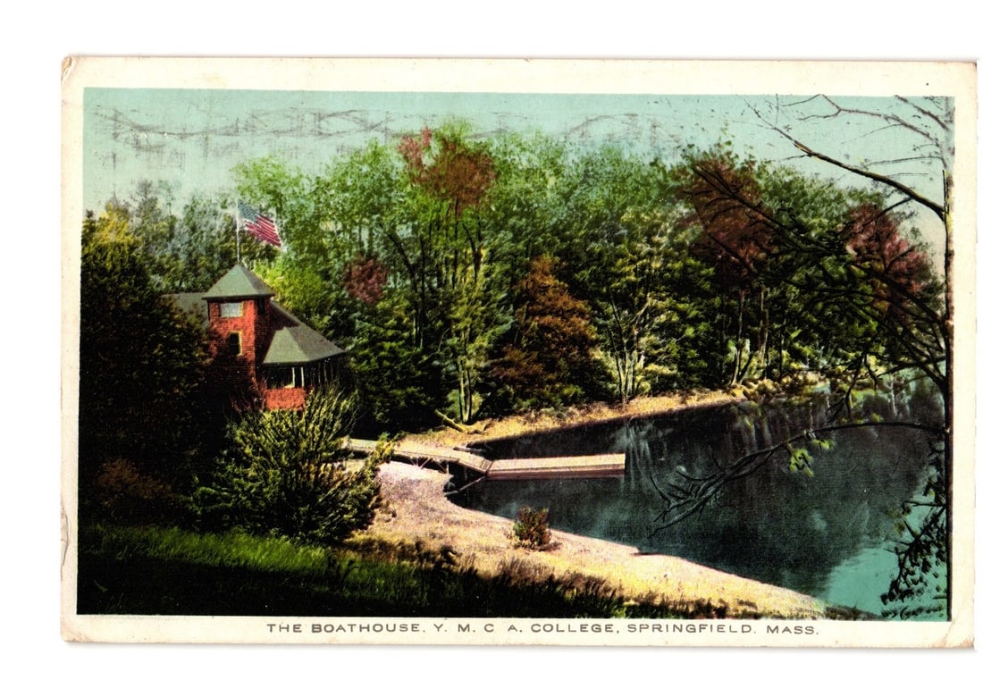 Vintage postcard of The Boathouse, Y.M.C.A. College, Springfield, Massachusetts, early 20th century: A chromolithograph postcard featuring The Boathouse at Y.M.C.A. College in Springfield, Massachusetts. The image depicts a two-story boathouse with a red roof and dark walls, topped with an American f