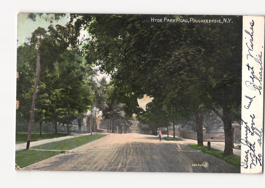 Historic Hyde Park Road in Poughkeepsie, N.Y., showing a tree-lined street scene postcard.: A view of Hyde Park Road in Poughkeepsie, New York, depicting a long, straight, tree-lined thoroughfare. The road, possibly dirt or asphalt, features wide grassy verges. Mature trees with dense foliag